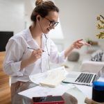Cheerful businesswoman having online conversation with client